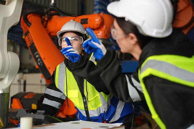 two workers looking at equipment in warehouse